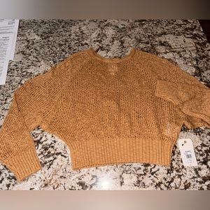 Golden/bright rust sheer sweater. Loose sleeves. length hits at waistband.